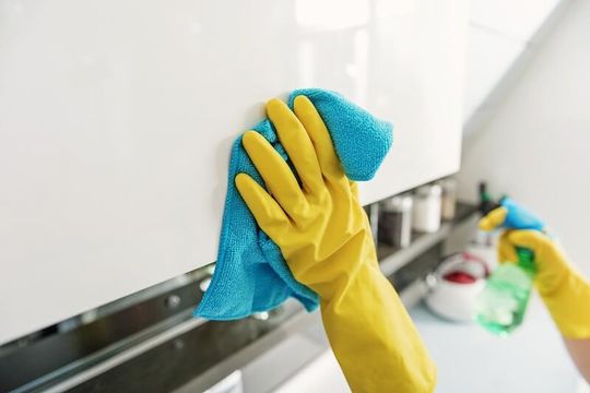 A person cleaning using a cloth